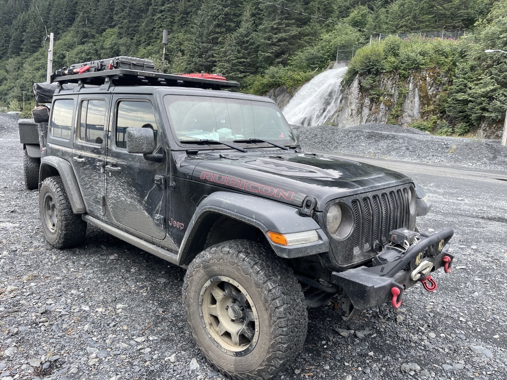 The Blackrock Overland Wrangler Rubicon and trailer parked at an alpine lake